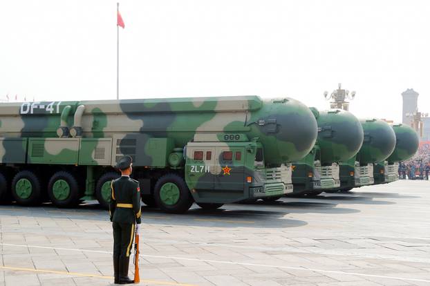 Military vehicles carrying DF-41 intercontinental ballistic missiles travel past Tiananmen Square during the military parade marking the 70th founding anniversary of People