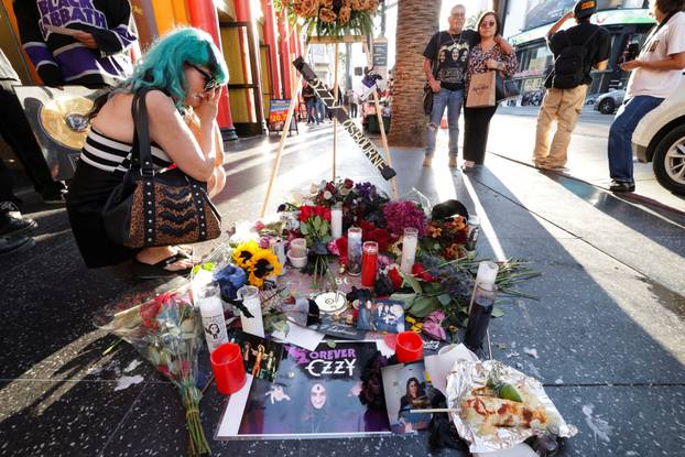 Flowers and pictures are placed on the star of late Ozzy Osbourne at the Hollywood Walk of Fame in Los Angeles