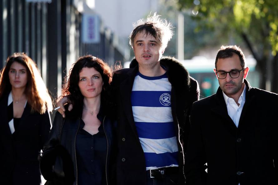 British rocker Pete Doherty leaves the Paris court with his friend Katia De Vidas and his lawyer Arash Derambarsh in Paris