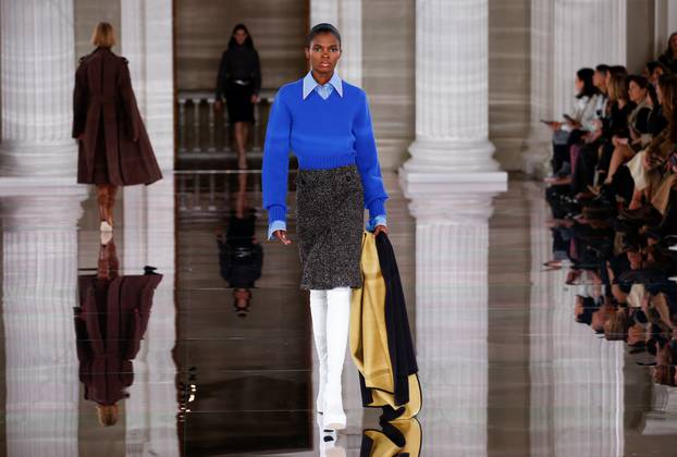 Models present creations at the Victoria Beckham catwalk show during London Fashion Week in London