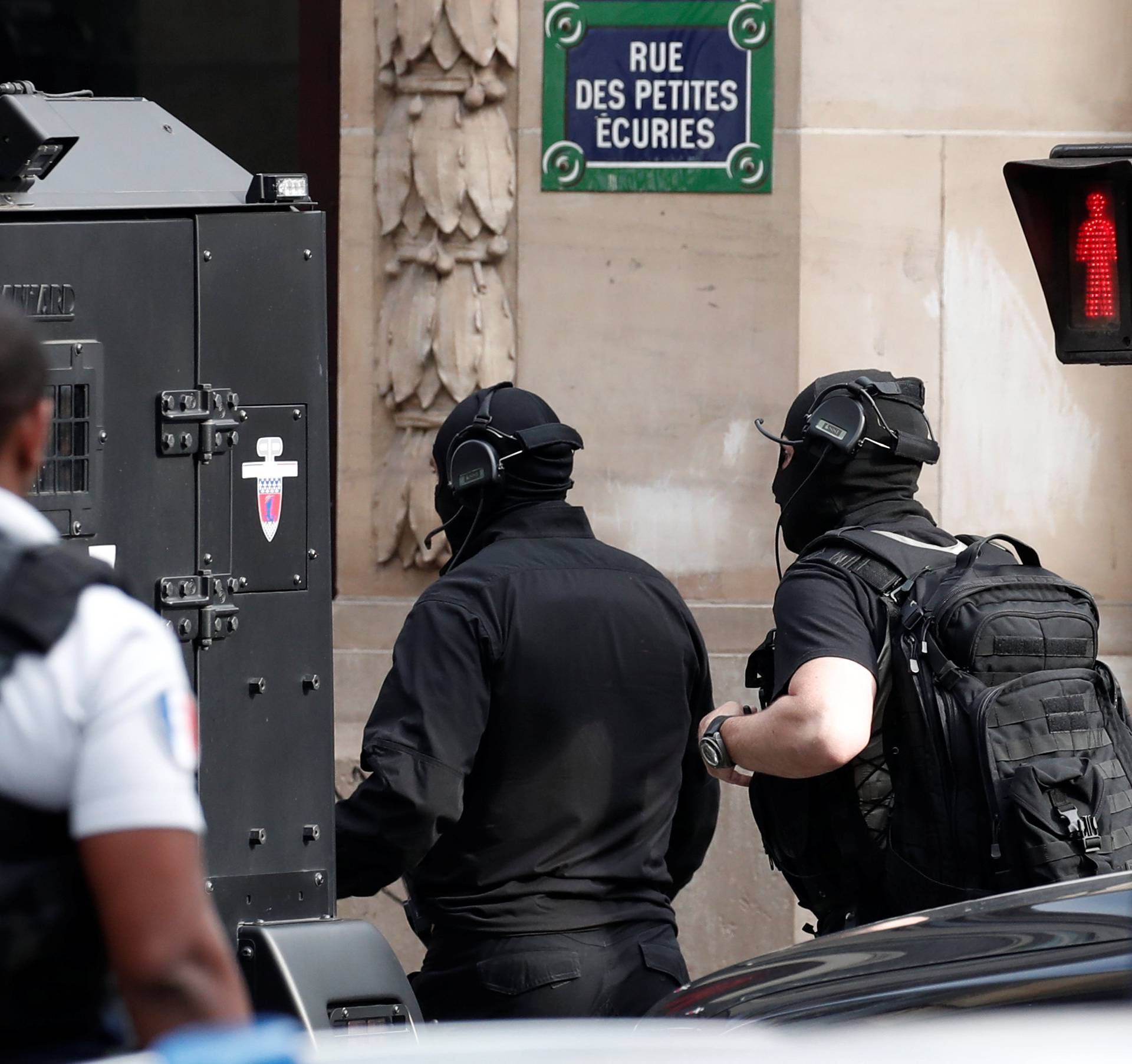 French special police forces (BRI) secure the street as a man has taken people hostage at a business in Paris