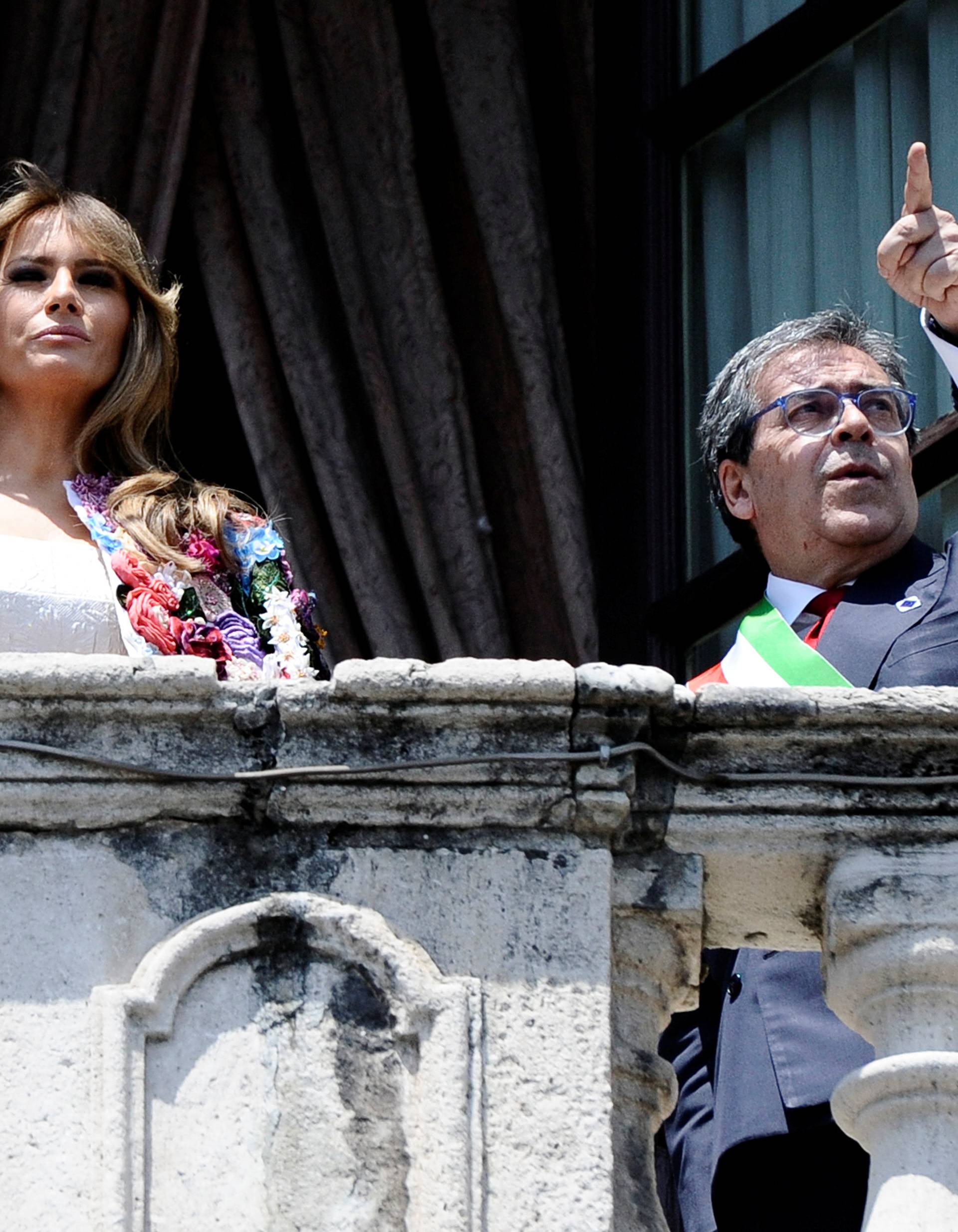 Mayor of Catania Enzo Bianco gestures next to U.S. first lady Melania Trump from the balcony of the Town Hall in Catania