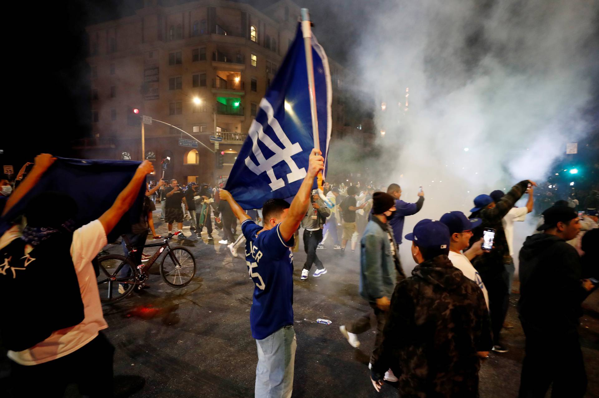 People celebrate Los Angeles Dodgers' victory at the end of game 6 of the 2020 World Series between Los Angeles Dodgers and Tampa Bay Rays, in Los Angeles, California