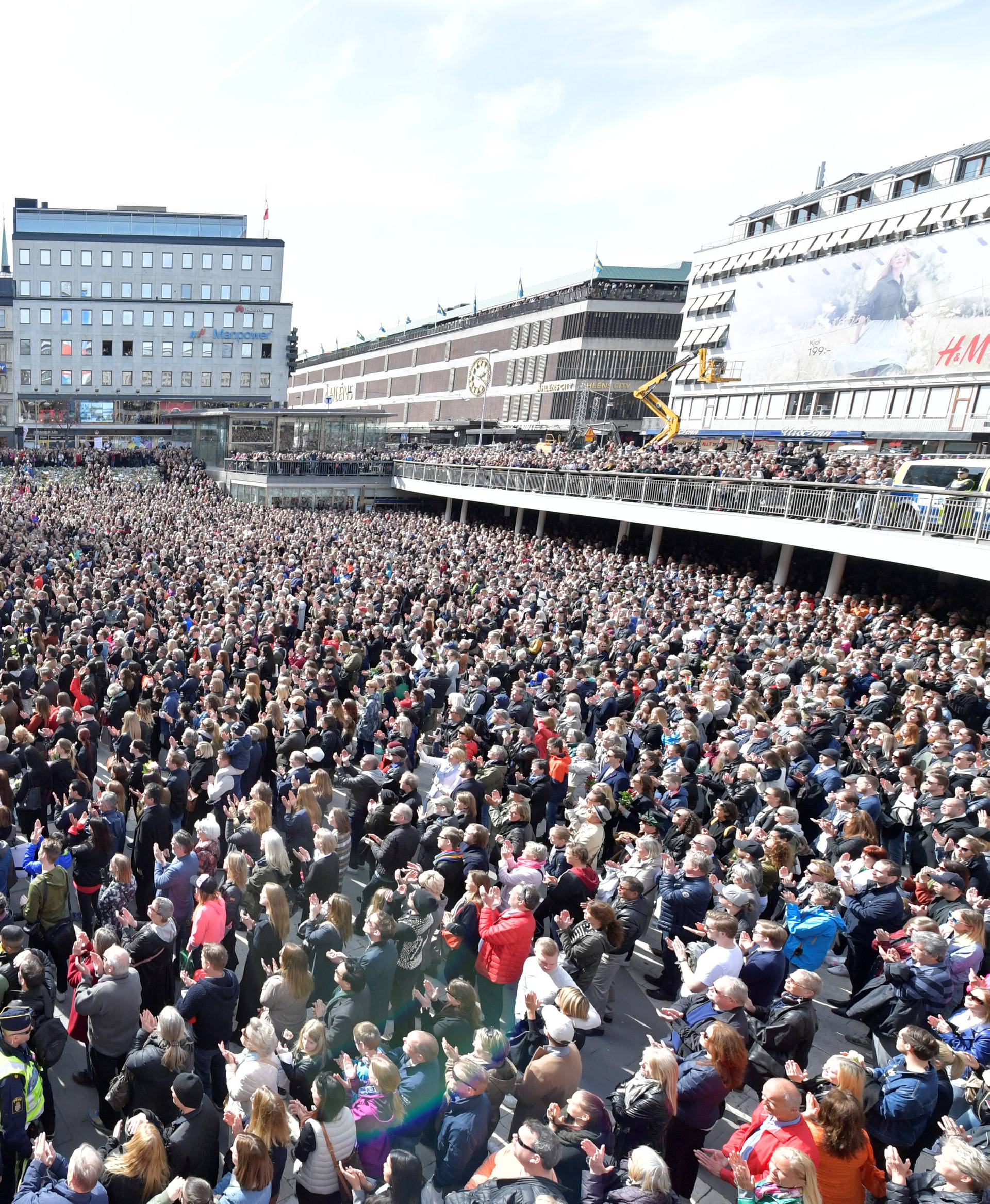 People gather in Sergels torg in central Stockholm for a "Lovefest" vigil against terrorism following Friday's attack