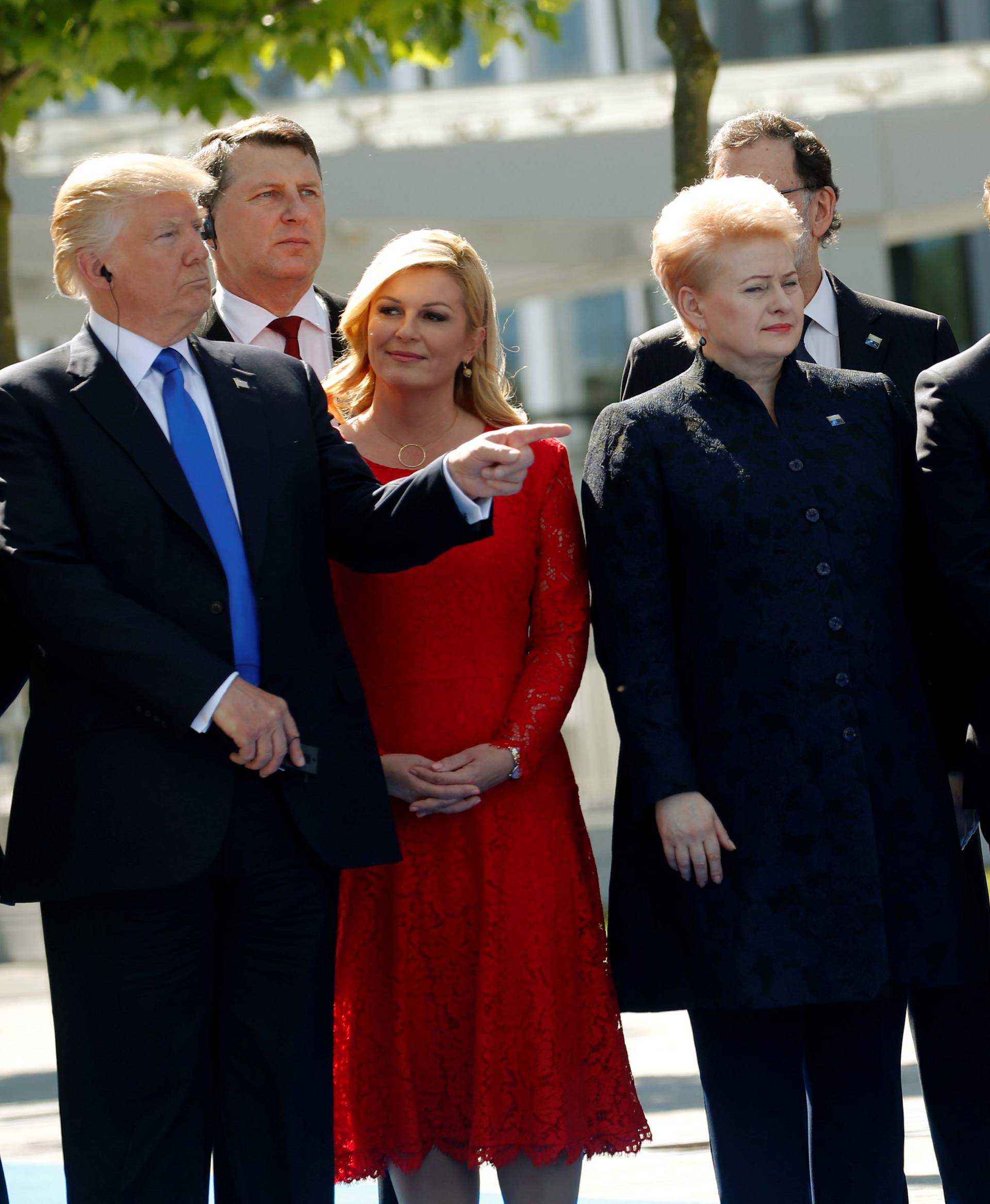 U.S. President Trump gestures next to Croatia's President Grabar-Kitarovic, Germany's Chancellor Merkel, France's President Macron, Belgium's PM Michel and Luxembourg's PM Bettel during a NATO summit at their new headquarters in Brussels