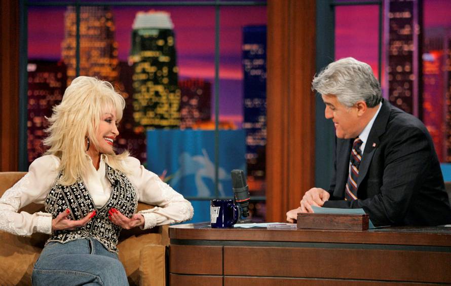 FILE PHOTO: Singer Parton gestures as she is interviewed by Jay Leno during the taping of "The Tonight Show with Jay Leno" in Burbank