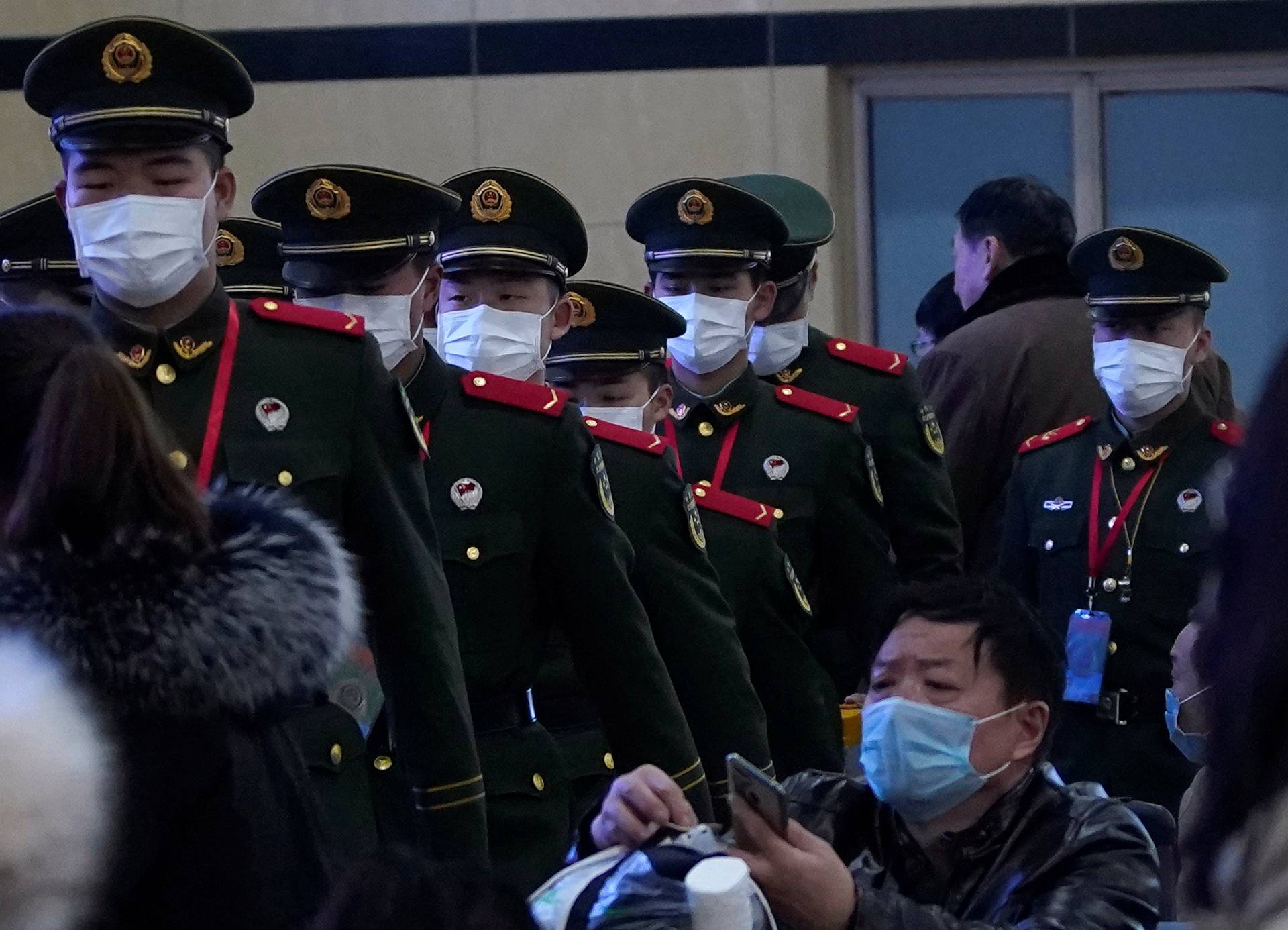 Paramilitary police officers wearing masks are seen at Shanghai railway station in Shanghai