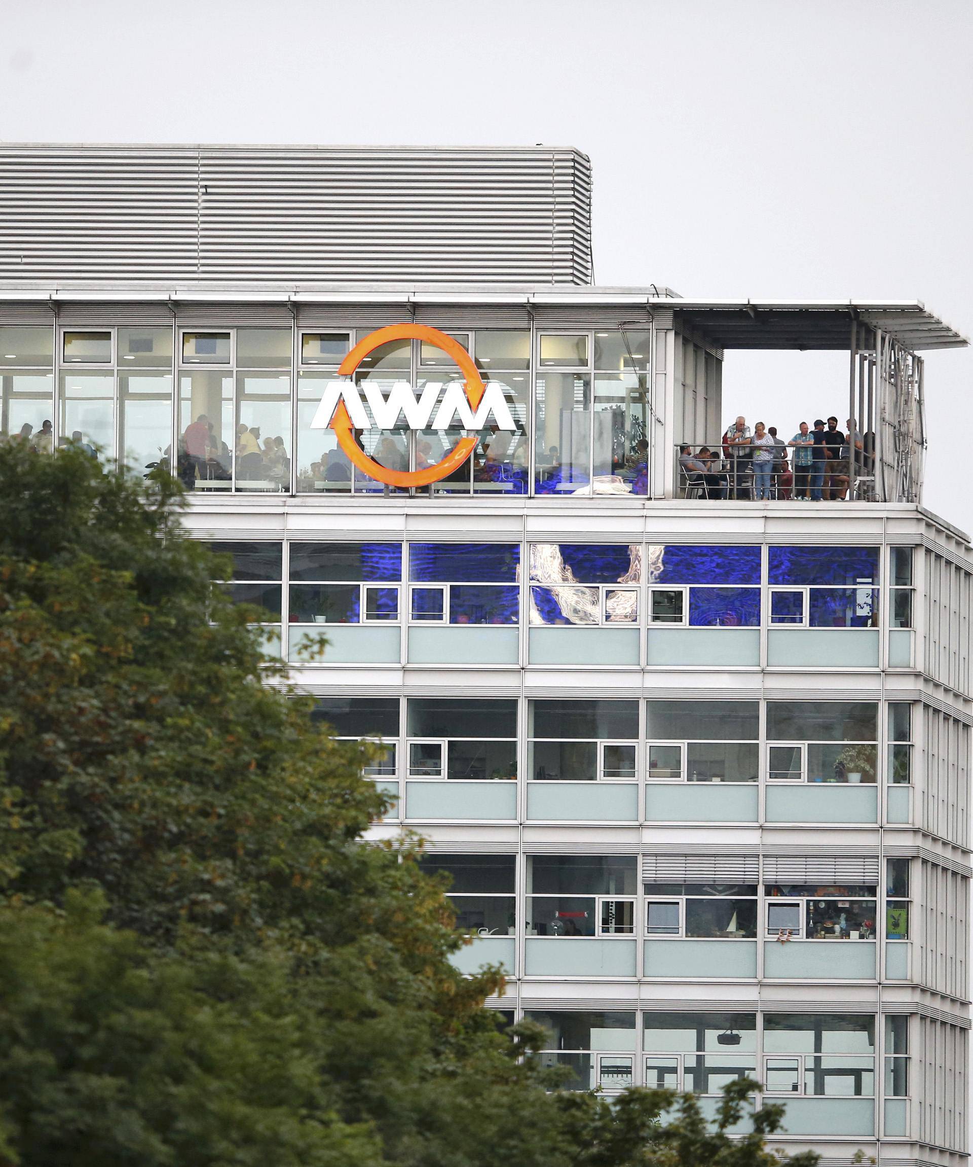 People stand on balcony of building overlooking scene of a shooting rampage in Munich