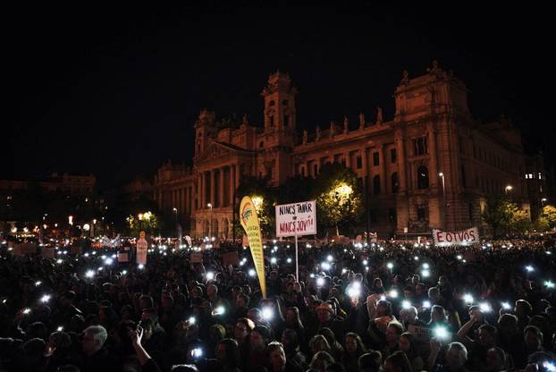 People light up their mobile phones during a protest in support of teachers fighting for higher wages and teachers sacked for protesting, in Budapest