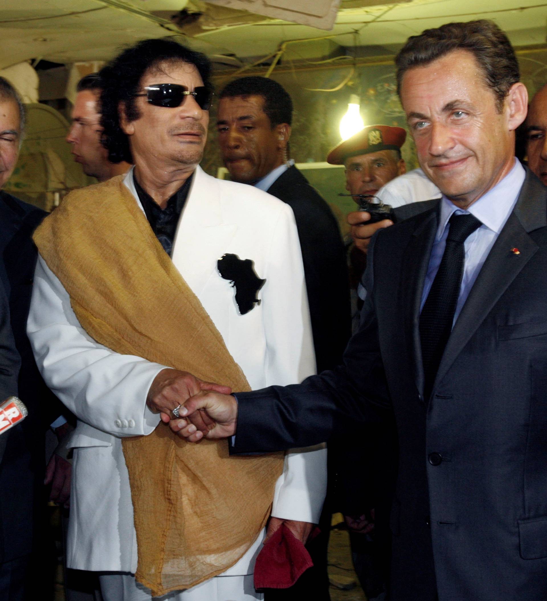 FILE PHOTO: Libya's President  Gaddafi greets his counterpart from France Sarkozy at Bab Azizia Palace in Tripoli