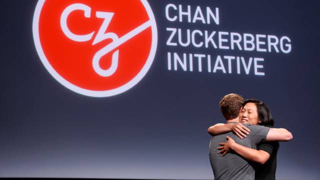 Pricilla Chan embraces her husband Mark Zuckerberg while announcing the Chan Zuckerberg Initiative to "cure, prevent or manage all disease" by the end of the century during a news conference at UCSF Mission Bay in San Francisco