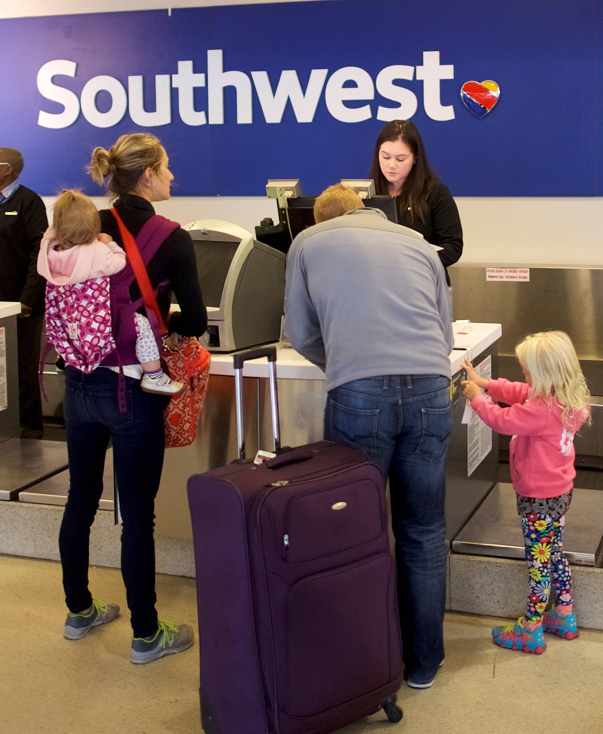 A family check in for their Southwest flight in Philadelphia International Airport
