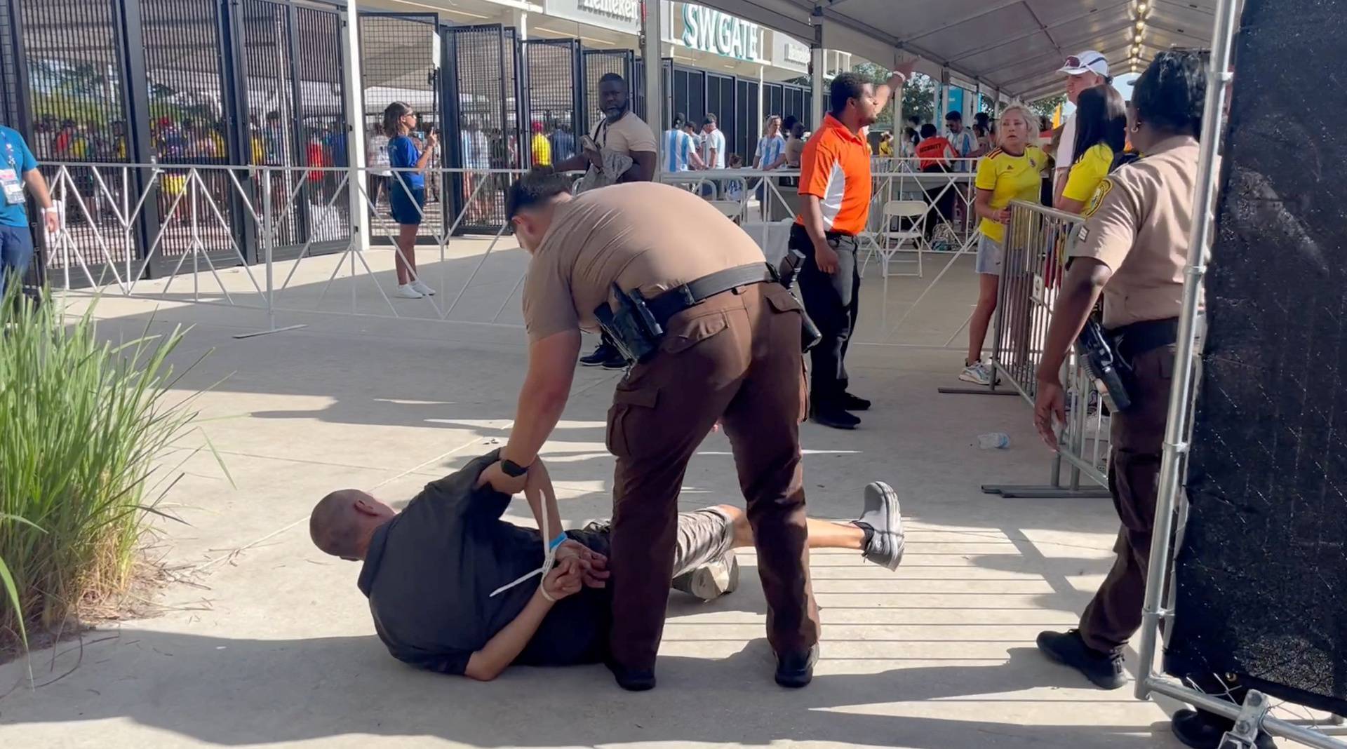 A man is detained by the police at Hard Rock Stadium, in Miami