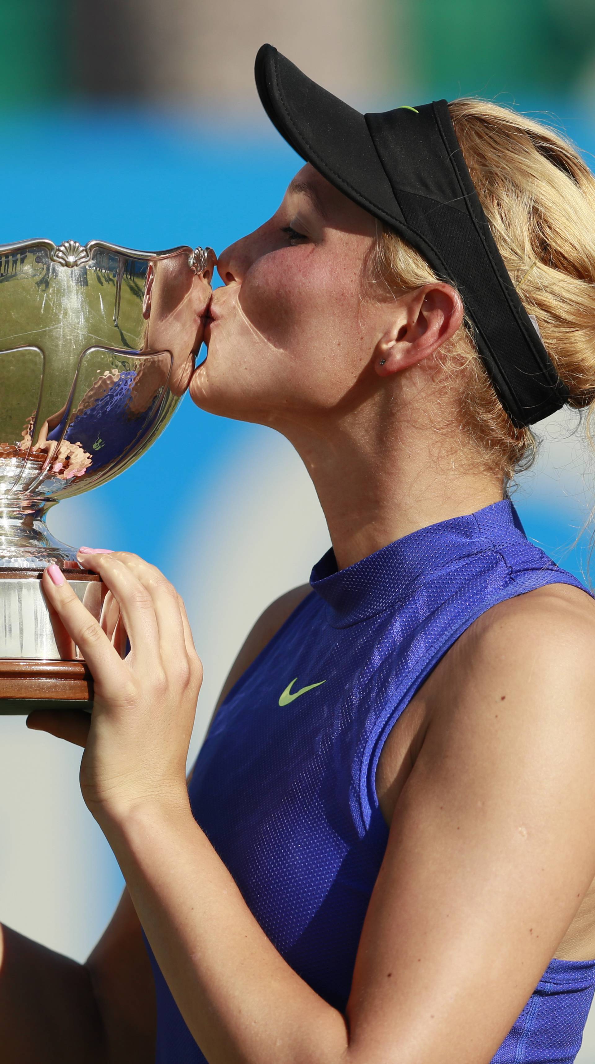 Croatia's Donna Vekic celebrates winning the final with the trophy