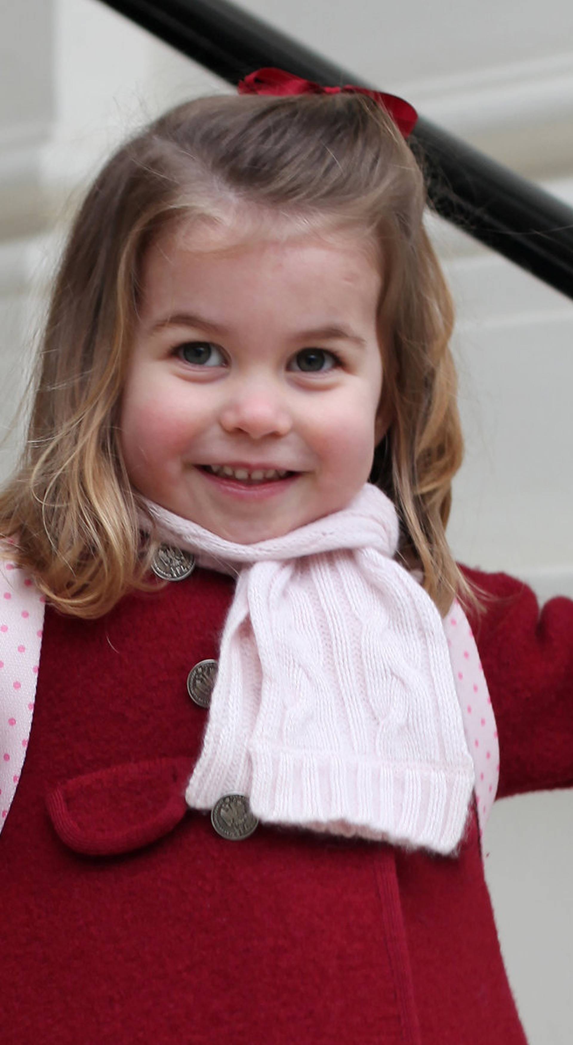 Britain's Princess Charlotte stands on the steps at Kensington Palace in a photograph taken taken by her mother and handed out by Britain's Prince William and Catherine, the Duchess of Cambridge