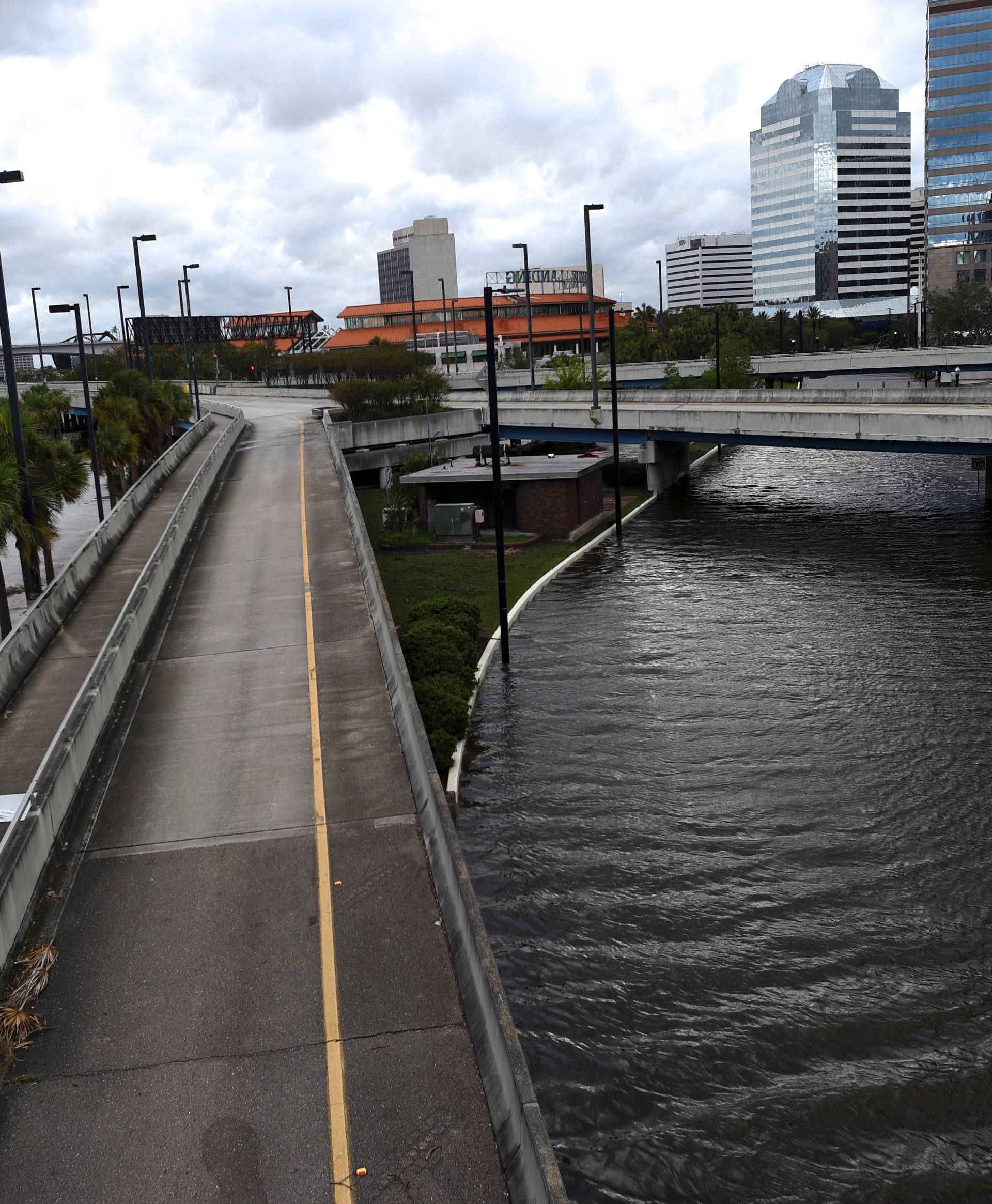 Women walk through floodwaters after Hurricane Irma in Jacksonville,