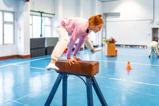 Redhead,Student,Practicing,Gymnastics,On,Pommel,Horse,,Showing,Balance,And