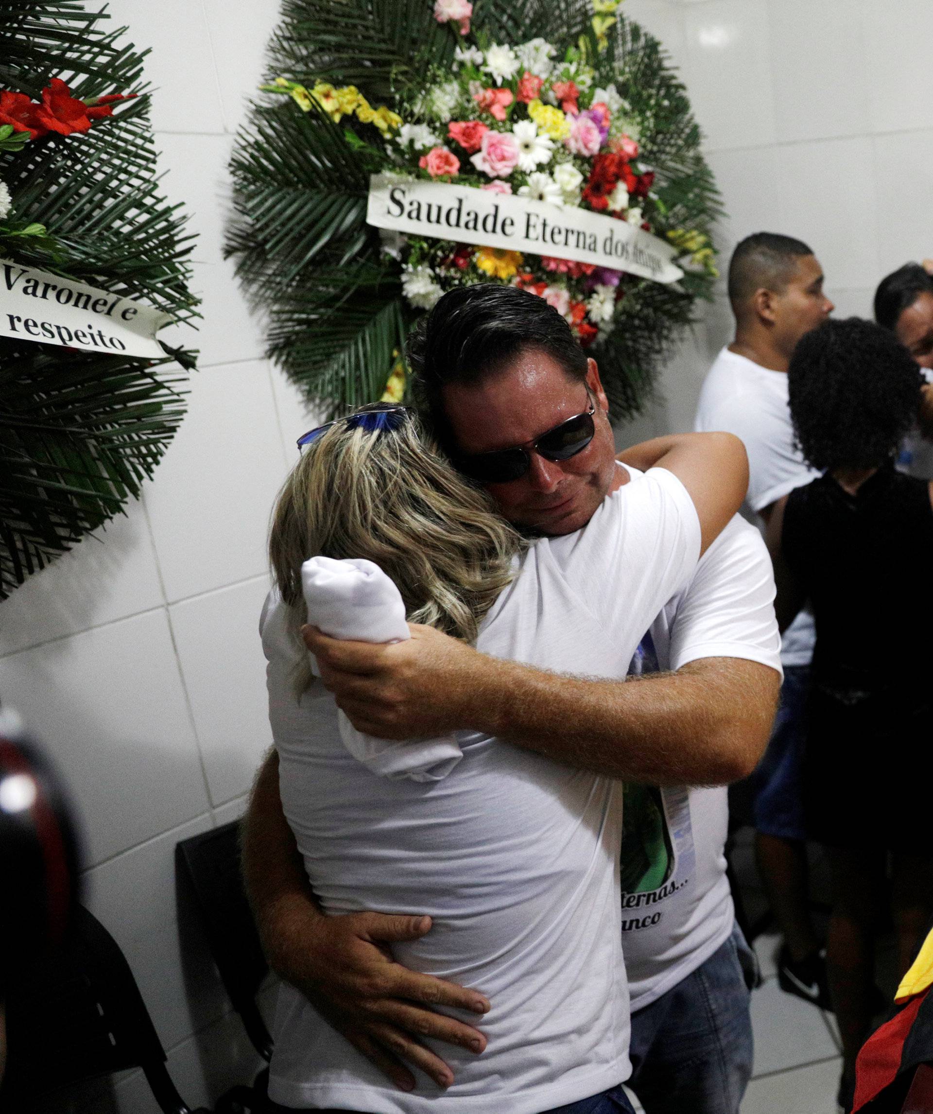 Relatives and friends of goalkeeper Christian Esmerio, 15, react during his funeral after a deadly fire at Flamengo soccer club's training center, in Rio de Janeiro