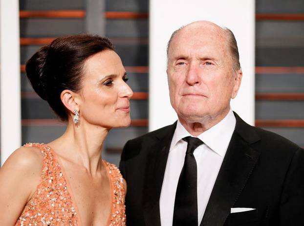 FILE PHOTO: Robert Duvall and wife, Luciana Duvall, arrive at the 2015 Vanity Fair Oscar Party in Beverly Hills