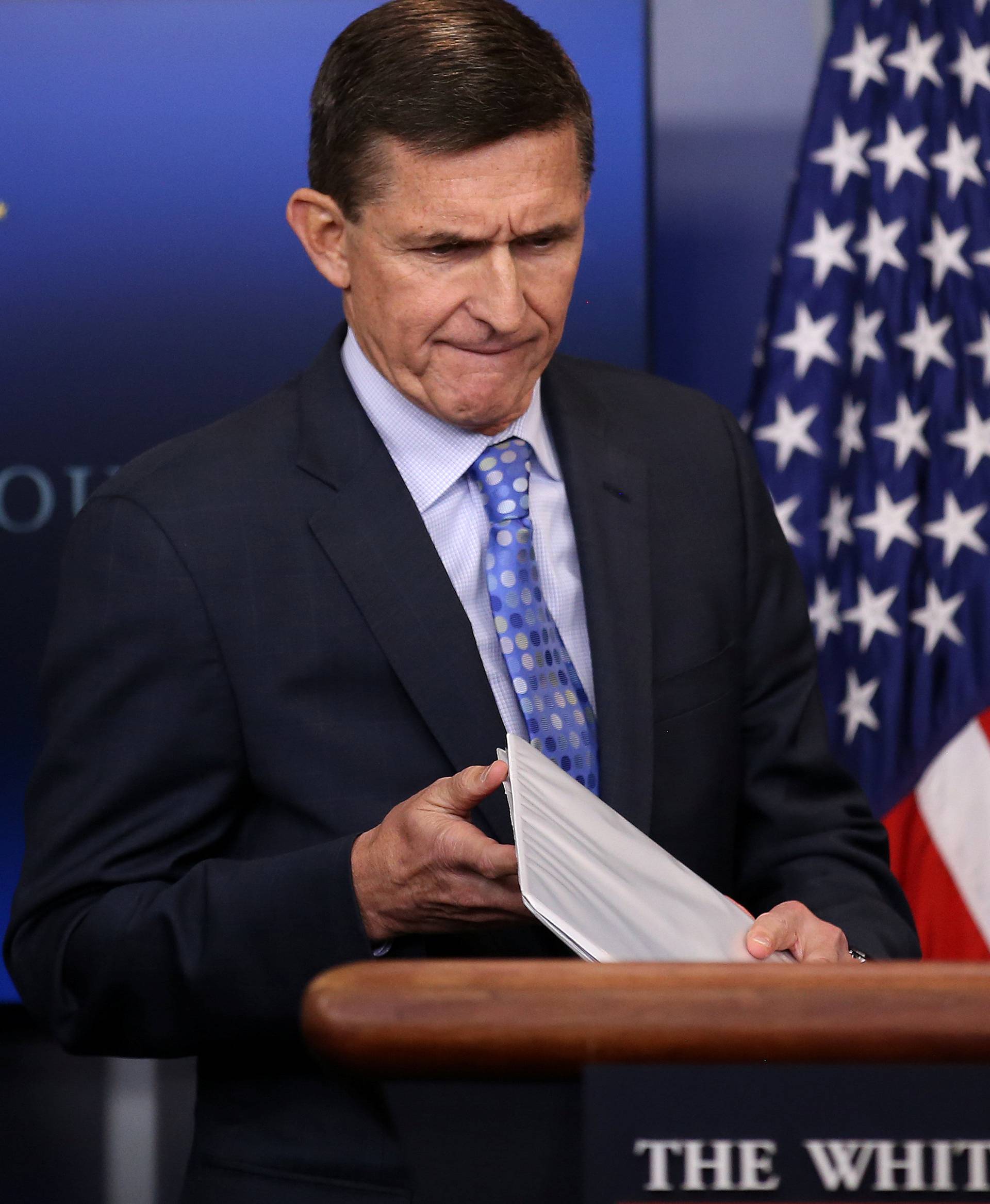 National security adviser General Michael Flynn (L) arrives to deliver a statement next to Press Secretary Sean Spicer during the daily briefing at the White House in Washington U.S.