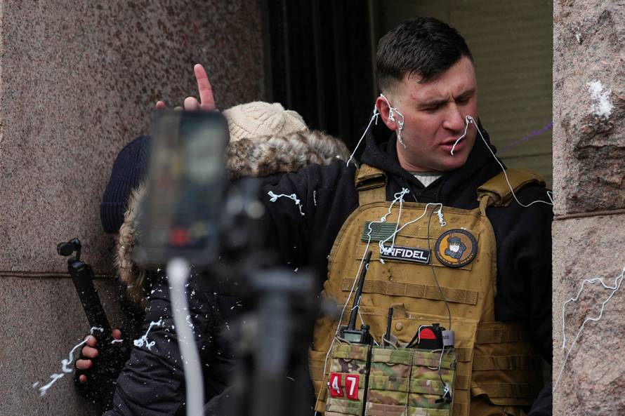 People attend the "March Against Minnesota Fraud" in Minneapolis
