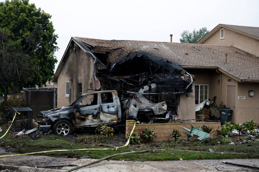 Crash scene after a civilian aircraft went down in a military neighborhood, in San Diego