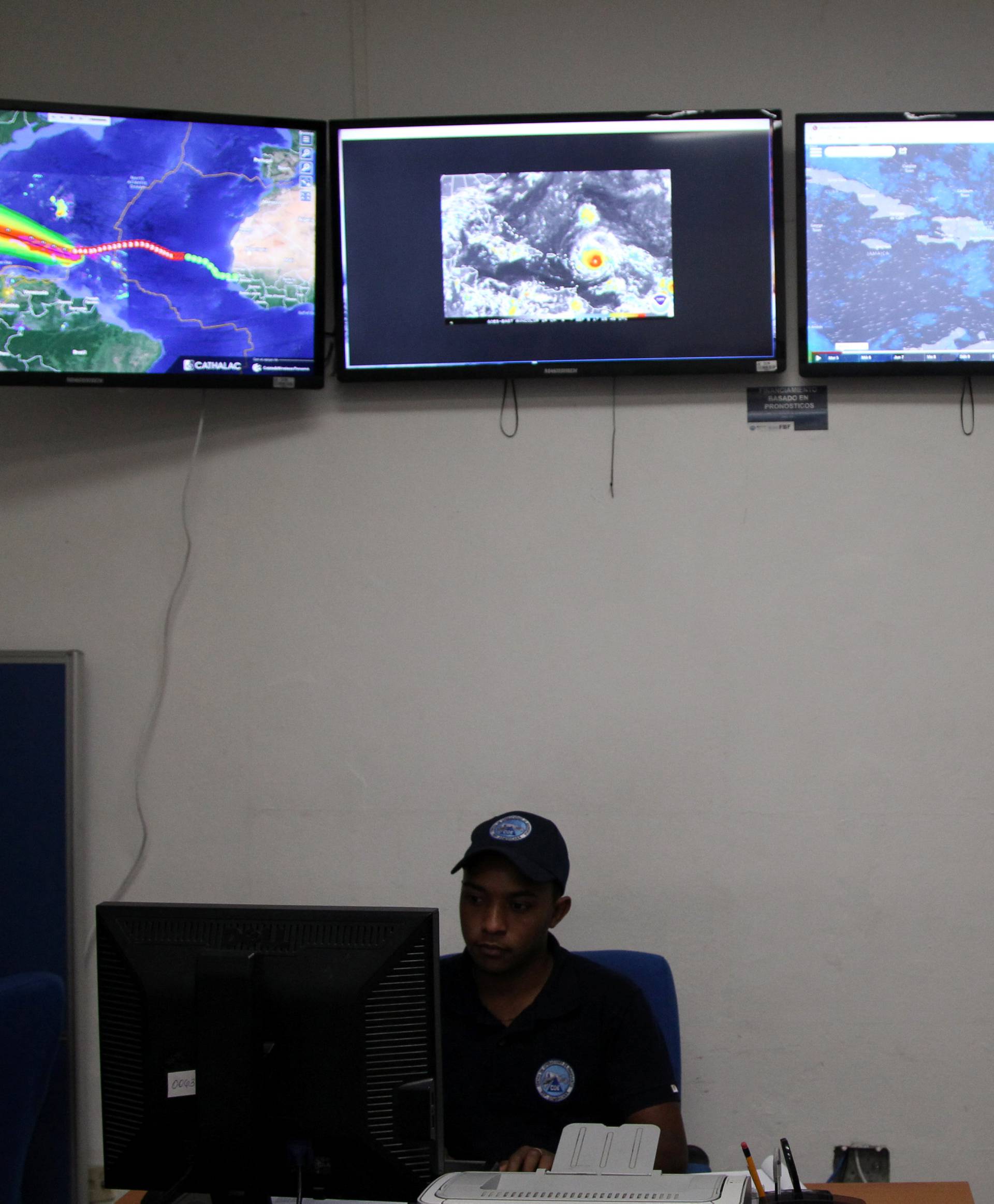 A member of the Emergency Operations Committee (COE) monitors the trajectory of Hurricane Irma in Santo Domingo