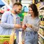 Happy couple with the cart shopping in supermarket