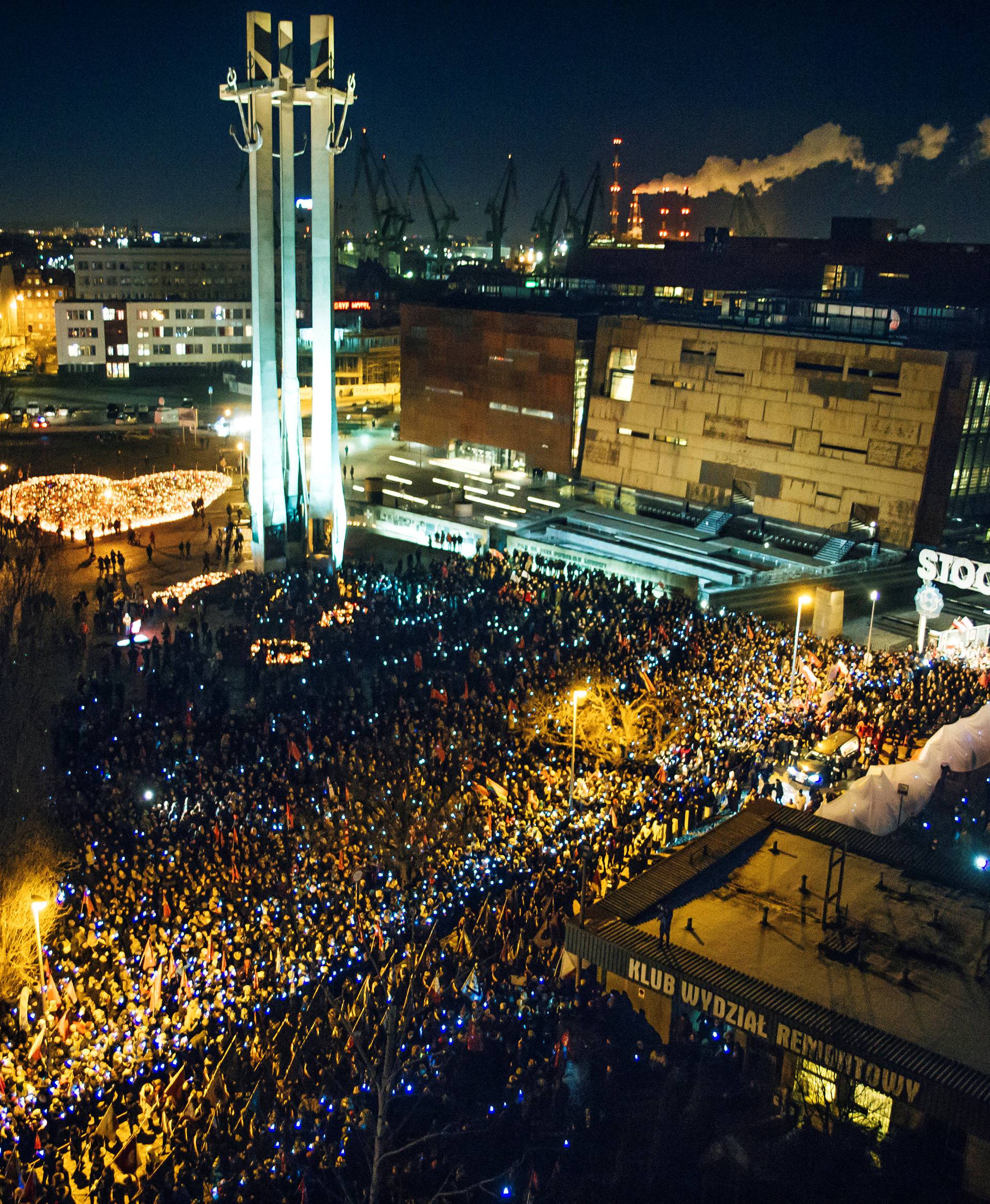 People take part in procession following the coffin of Pawel Adamowicz, Gdansk mayor who died after being stabbed at a charity event, in front of the European Solidarity Centre in Gdansk