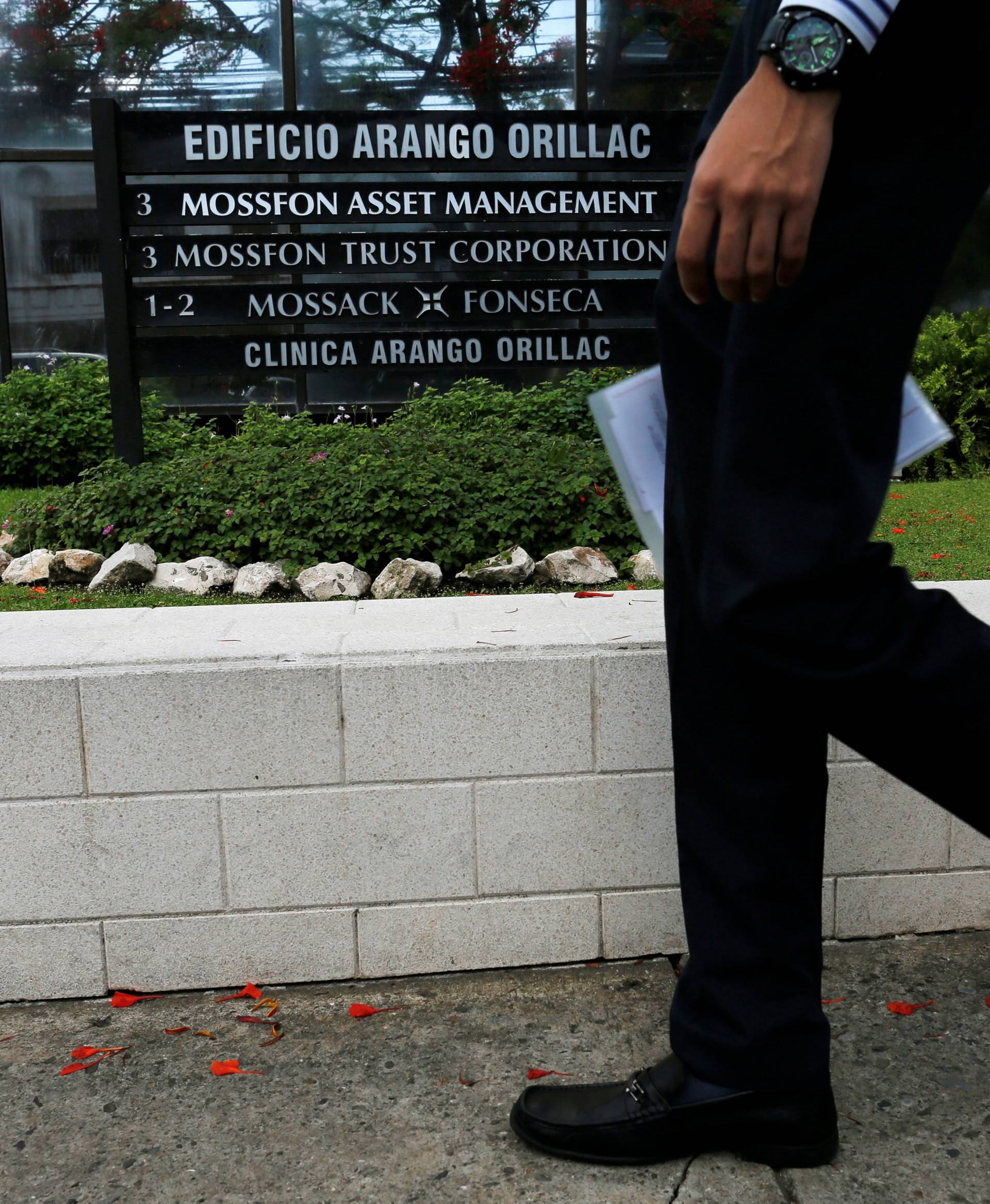 A man walks past a company list showing the Mossack Fonseca law firm at the Arango Orillac Building in Panama City