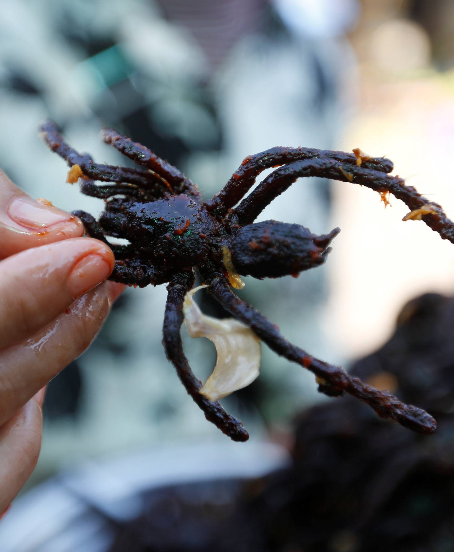 A woman sells fried tarantulas at a market in Kampong Cham province in Cambodia