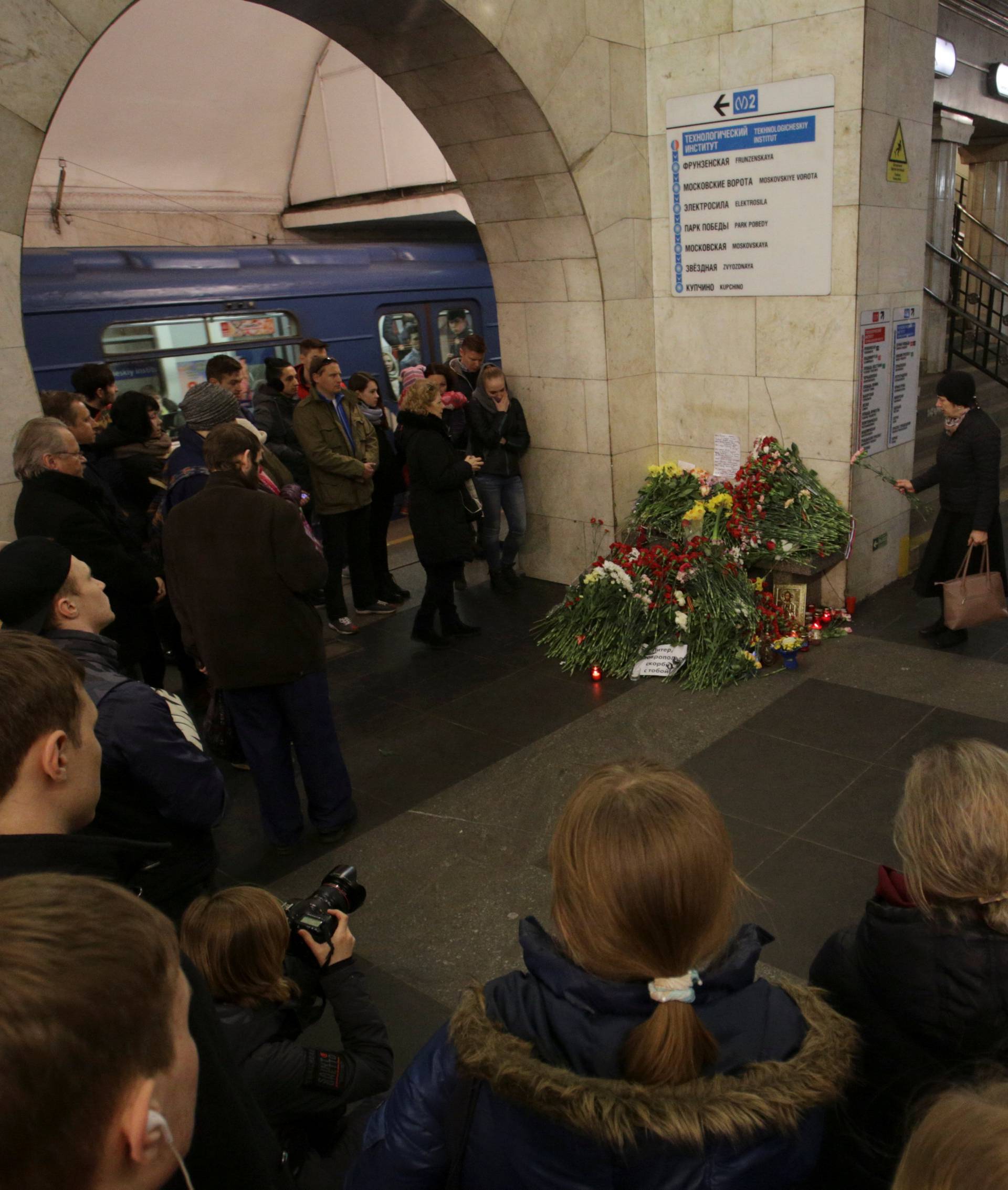 People mourn next to memorial site for victims of blast in St. Petersburg metro, at Tekhnologicheskiy institut metro station in St. Petersburg