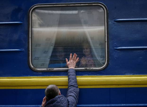 People wait to board an evacuation train at Kyiv central train station