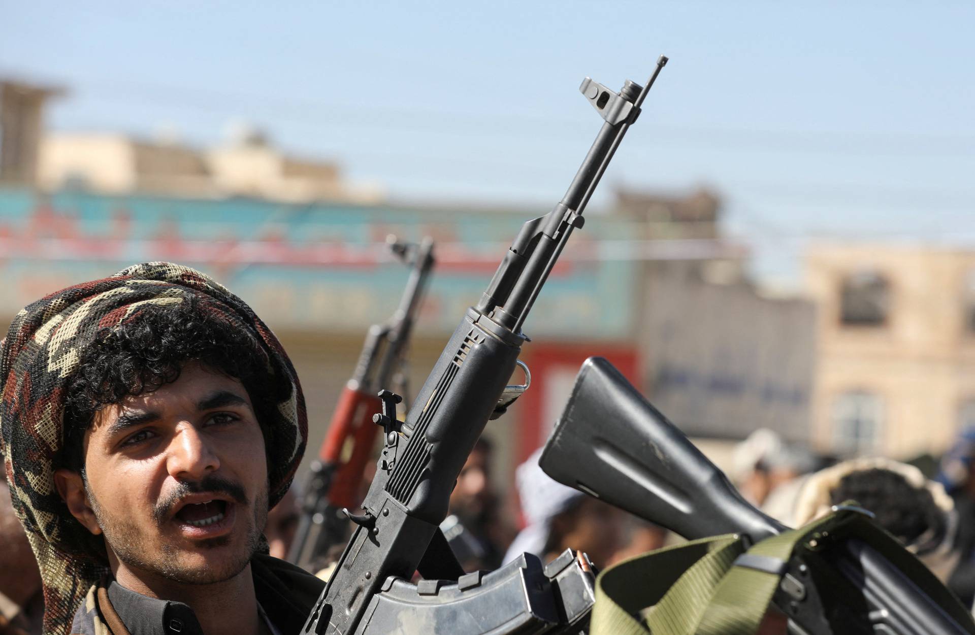 A newly recruited Houthi fighter shouts slogans during a ceremony at the end of his training in Sanaa