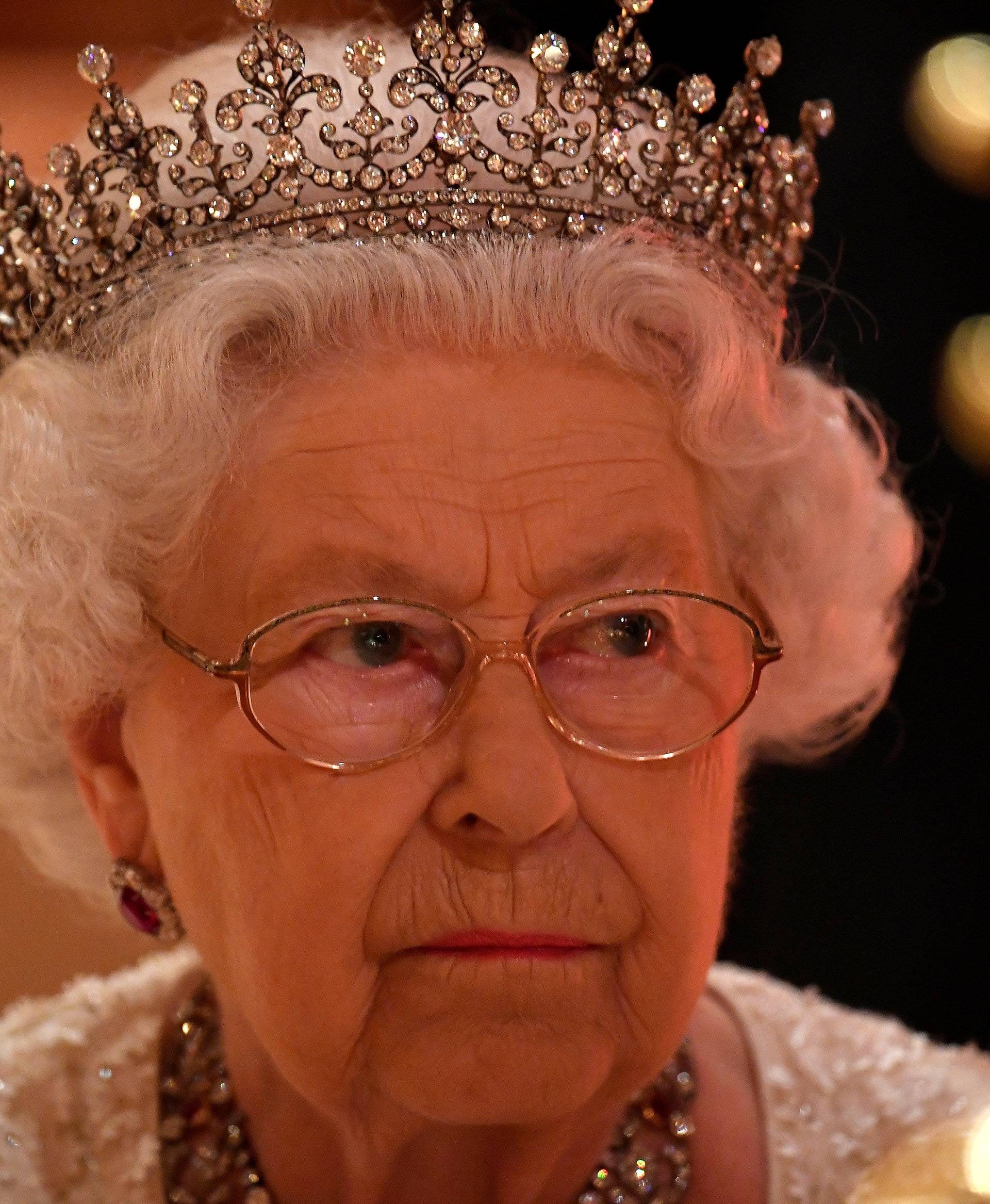 Britain's Queen Elizabeth listens during speeches at The Queen's Dinner during the Commonwealth Heads of Government Meeting at Buckingham Palace in London, Britain