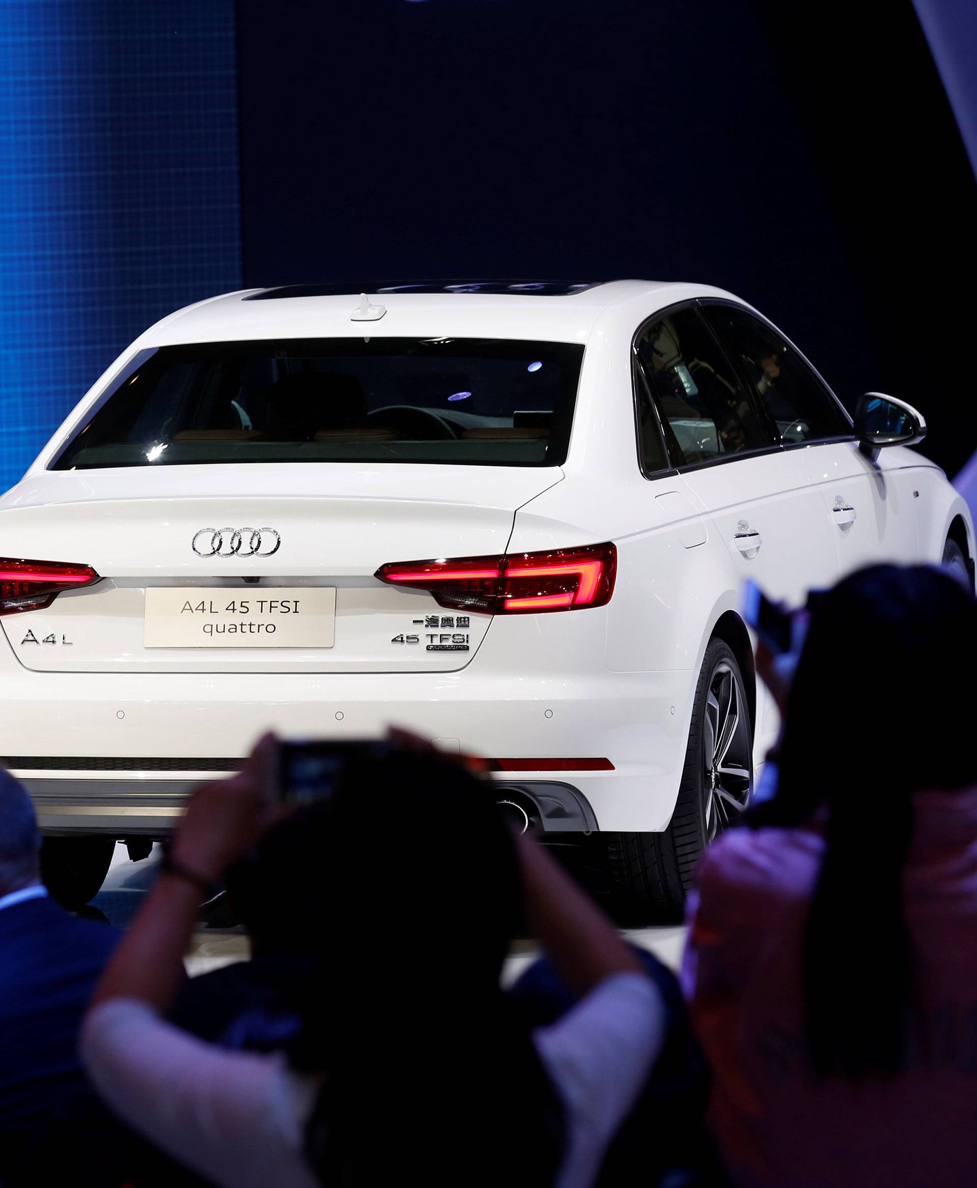 Visitors take picture of Audi A4L 45 TFSI quattro at its launching ceremony during the Auto China 2016 auto show in Beijing
