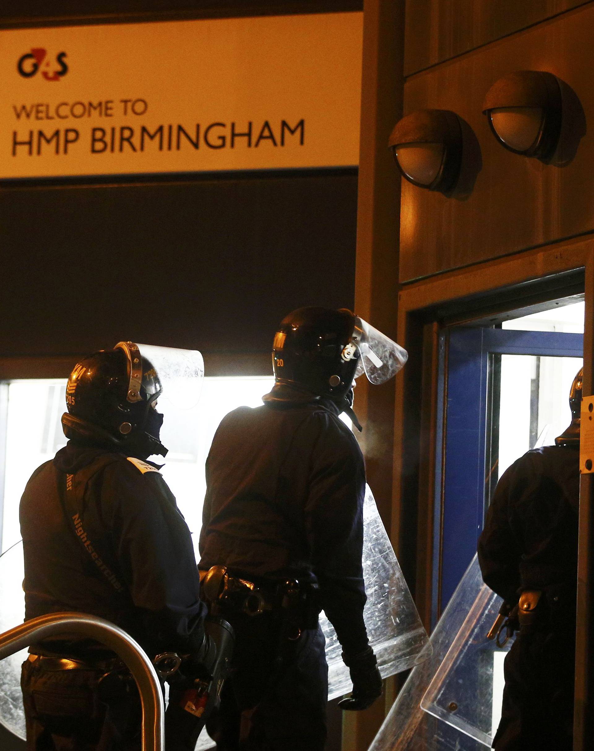 Police officers in riot gear enter Winson Green prison, run by security firm G4S, after a serious disturbance broke out, in Birmingham