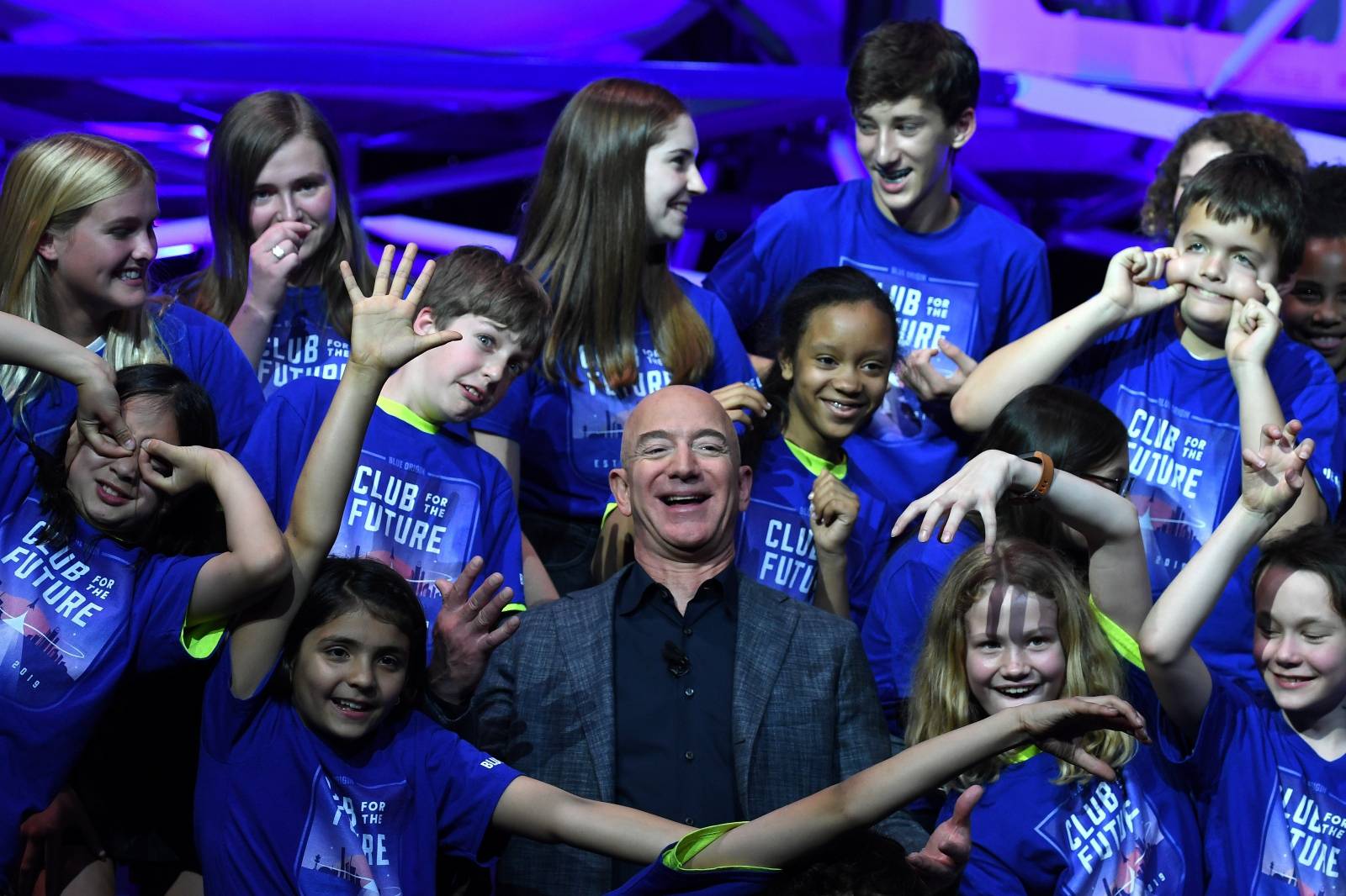 Founder, Chairman, CEO and President of Amazon Jeff Bezos poses with children from 'Club for the Future' after his space company Blue Origin's space exploration lunar lander rocket called Blue Moon was unveiled at an event in Washington