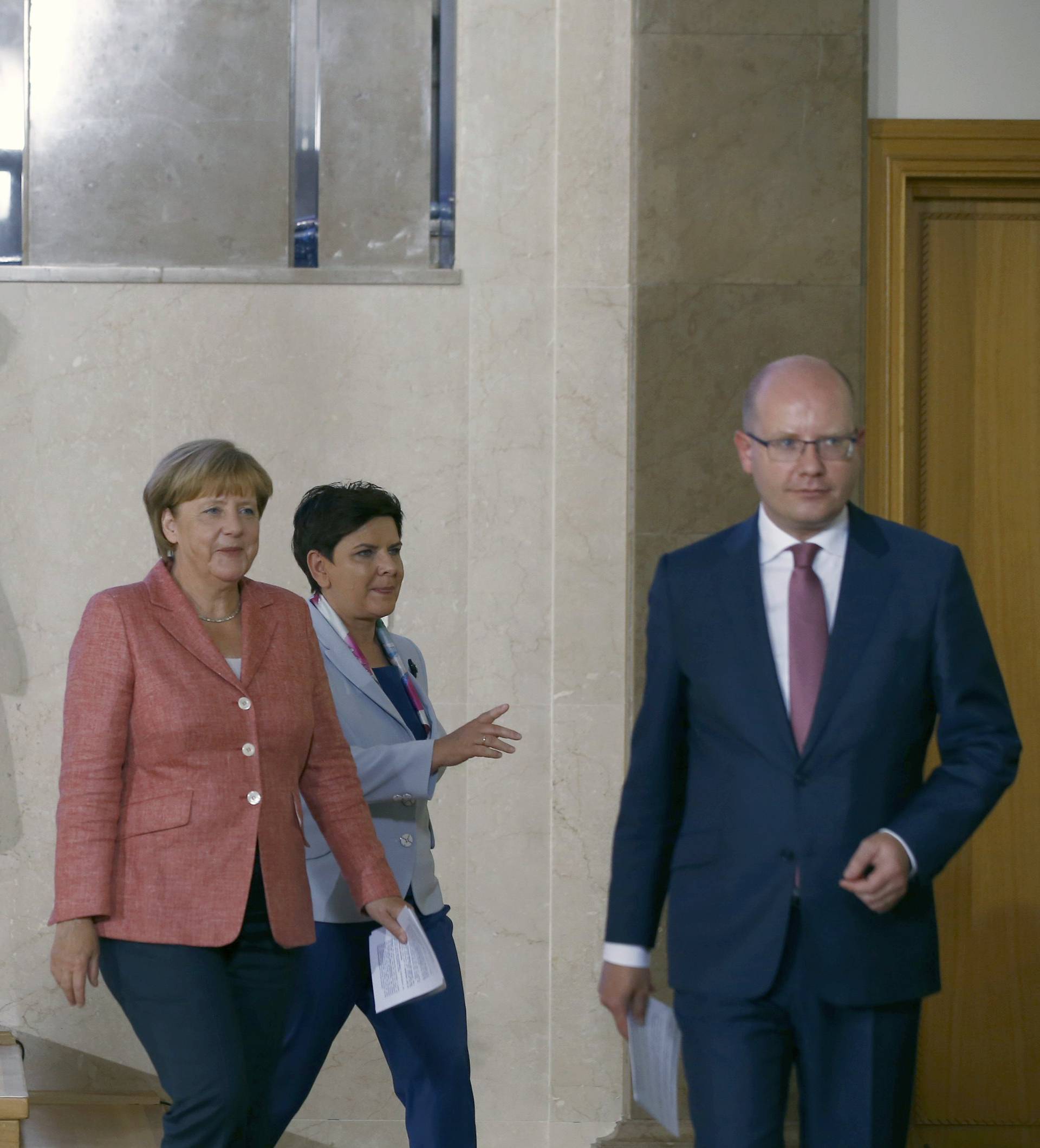 Hungary's PM Orban, Czech Republic's PM Sobotka, German Chancellor Merkel, Poland's PM Szydlo and Slovakia's PM Fico leave the news conference in Warsaw