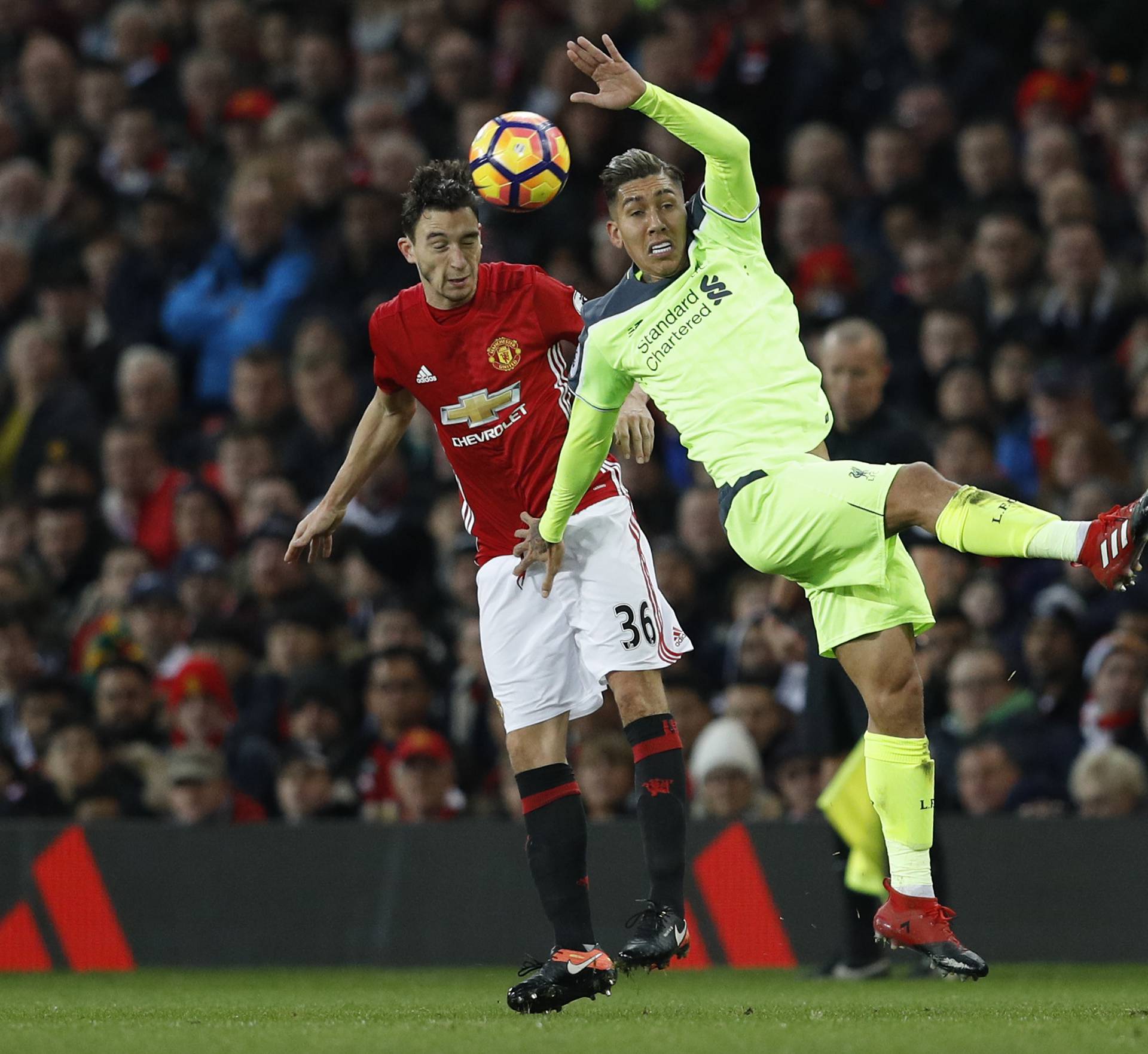 Manchester United's Matteo Darmian in action with Liverpool's Roberto Firmino