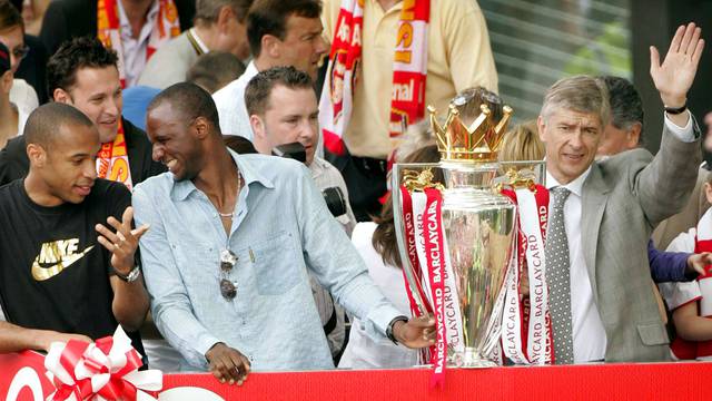 FILE PHOTO: Arsenal's Thierry Henry, Patrick Viera and manager Arsene Wenger celebrate during a victory parade