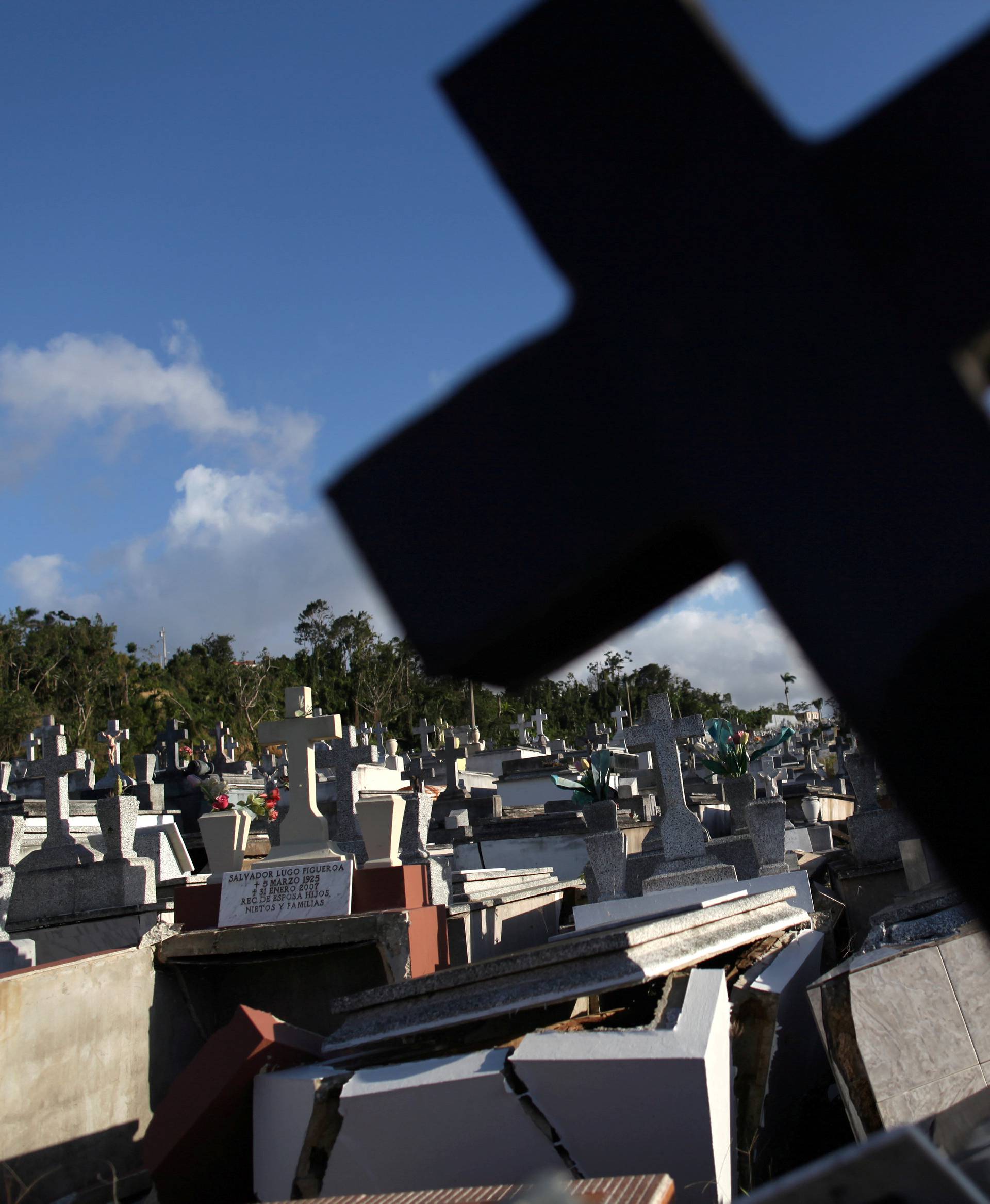 FILE PHOTO: Graves destroyed during Hurricane Maria in September 2017, are seen at a cemetery, in Lares