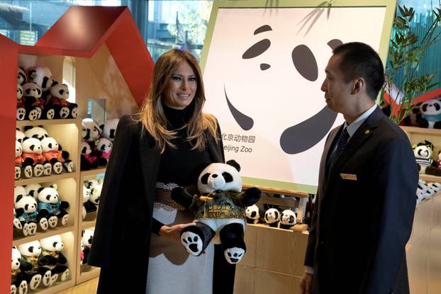 U.S. first lady Melania Trump poses with a panda plushie after visiting the panda enclosure at the zoo in Beijing, China