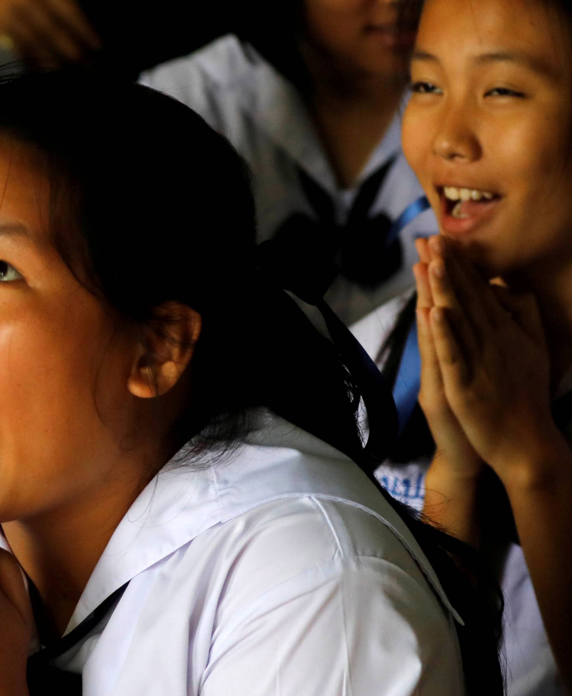 Classmates pray after their teacher announced some of the 12 schoolboys trapped inside a flooded cave, have been rescued, at Mae Sai Prasitsart school, in the northern province of Chiang Rai