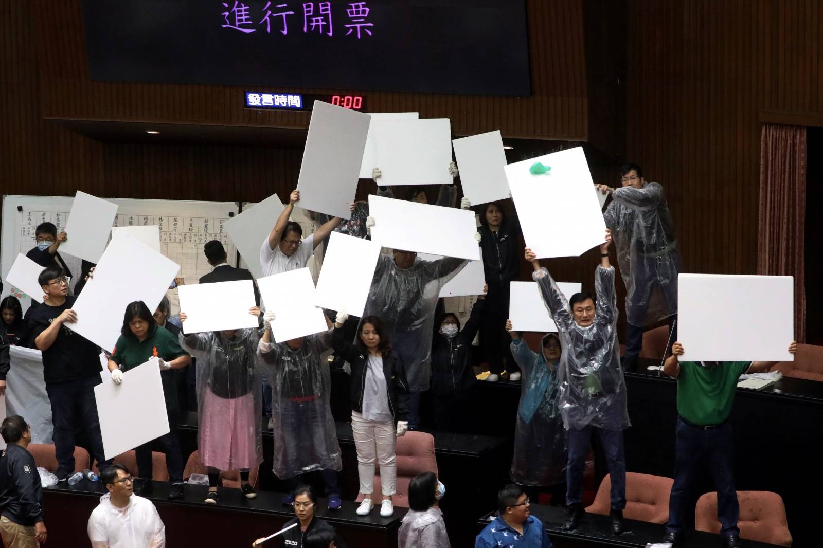 Lawmakers from Taiwan's ruling Democratic Progressive Party (DPP) with lawmakers from the main opposition Kuomintang (KMT) party throw water ballons at each other inside the parliament in Taipei,