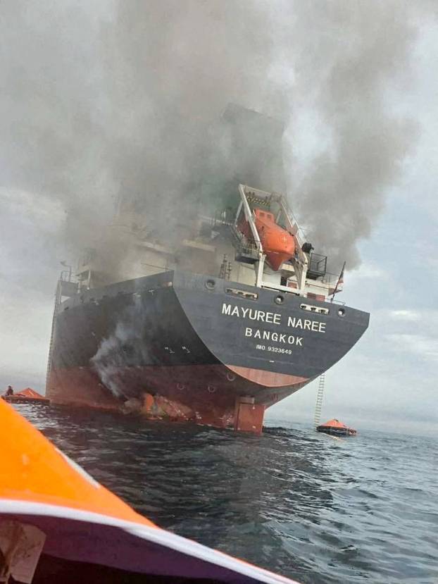 The Thailand-flagged cargo ship Mayuree Naree engulfed in black smoke in the Strait of Hormuz