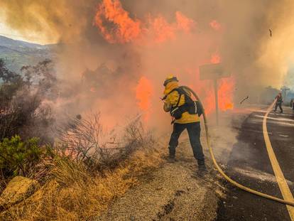 Firefighters work to extinguish a fire in Alpine, California