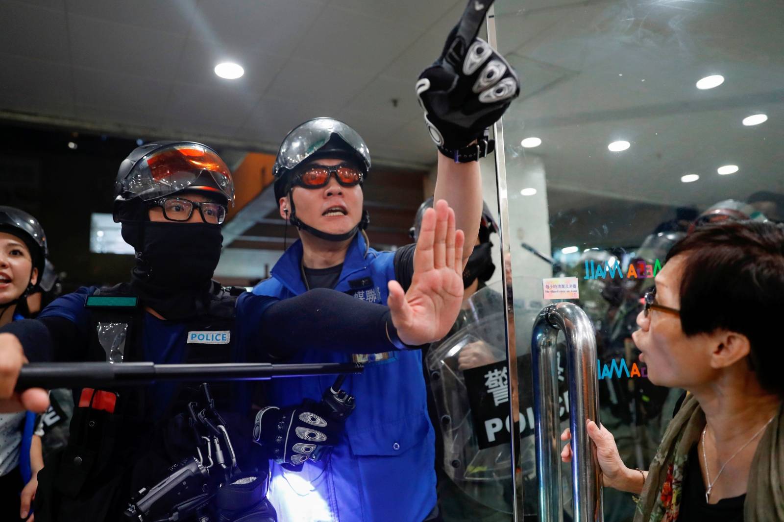 Riot police disperse anti-government protesters at shopping mall in Tai Po, Hong Kong