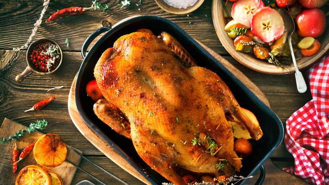 Roast,Christmas,Duck,With,Thyme,And,Apples,On,Rustic,Wooden