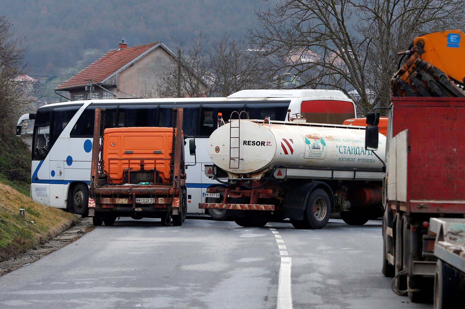 Kosovo Serbs block the road with trucks near the village of Rudine